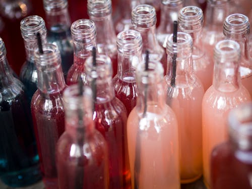 Clear Glass Bottles with Colorful Beverages