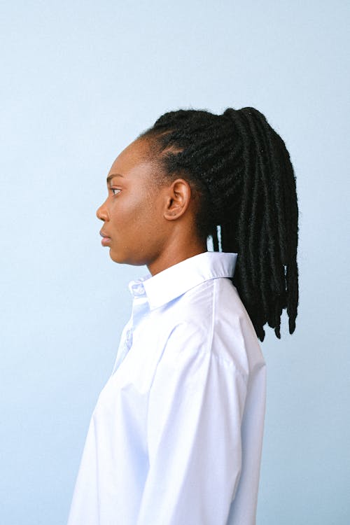 Side View Shot of a Woman in White Collared Shirt with Serious Face