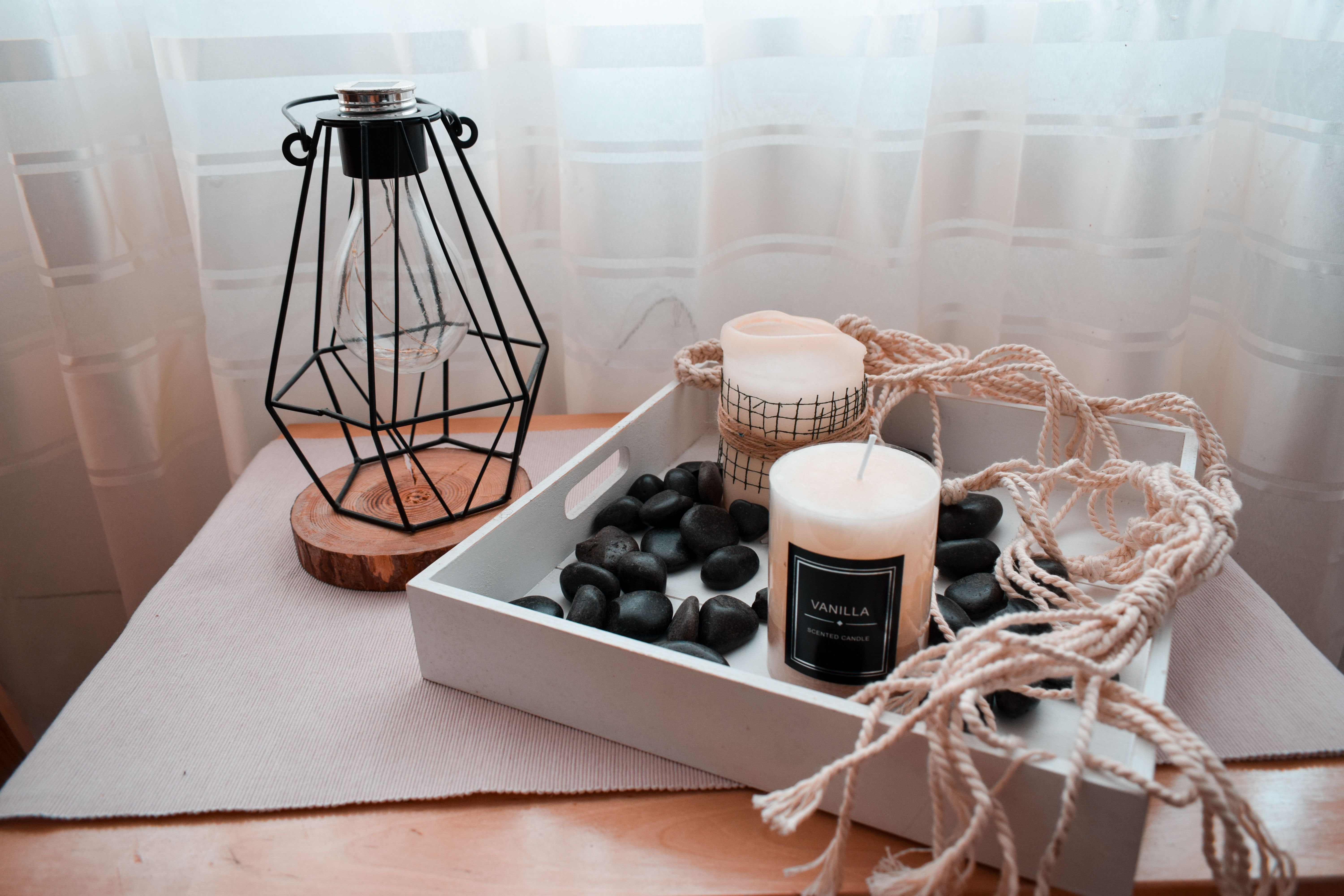 Scented candle and lantern kept on desk
