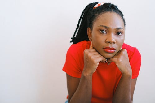 Woman in Red Crew Neck T-shirt With Hands On Chin