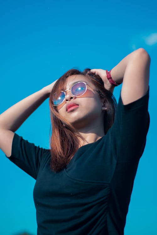 Woman Touching Her Hair while Projecting on the Camera