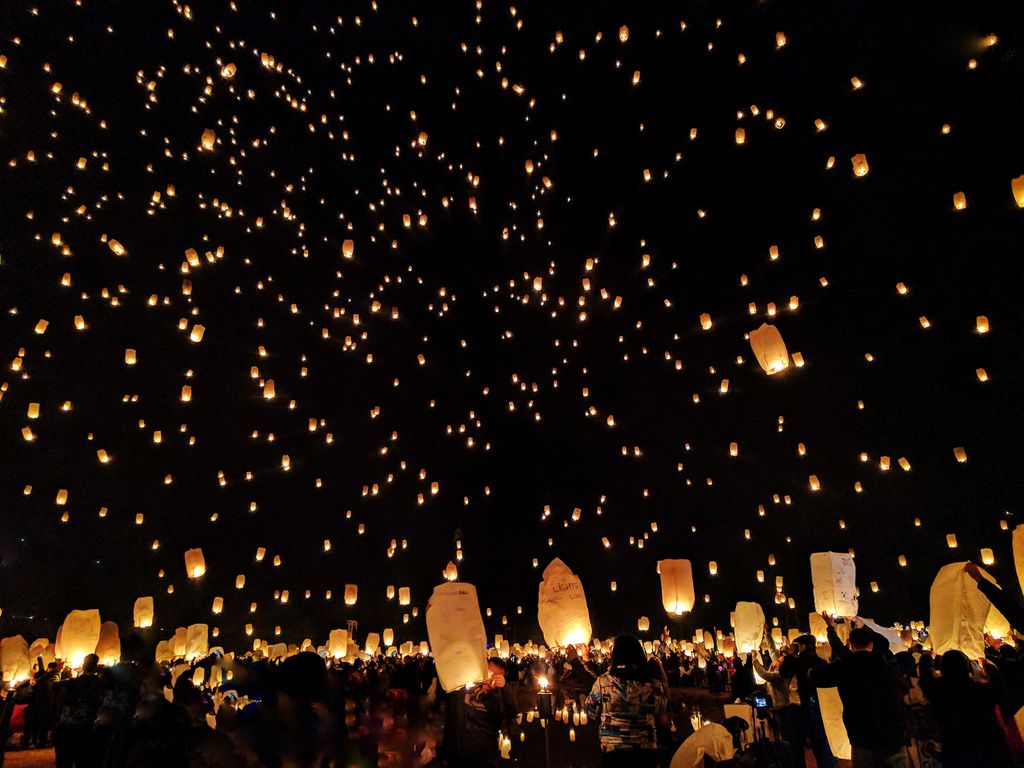 Thousands of glowing paper lanterns released into the night sky during a sky lantern festival