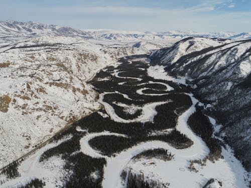 Riverbed of frozen river in mountainous terrain in winter