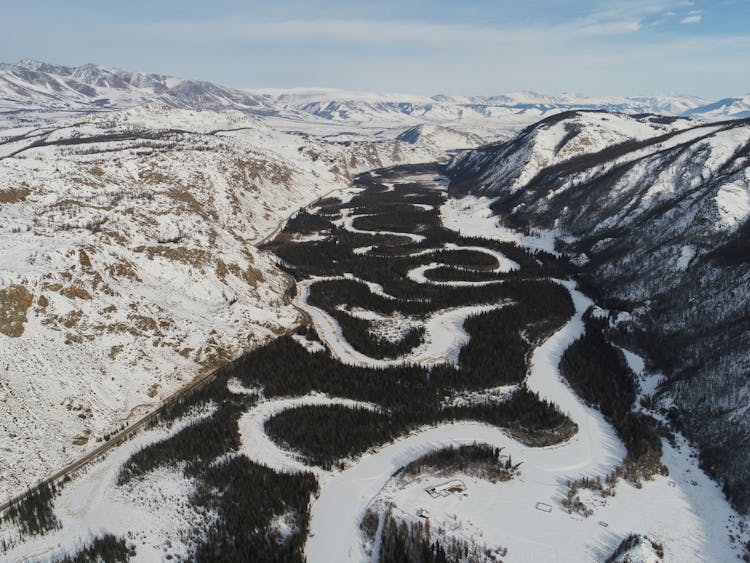 Riverbed Of Frozen River In Mountainous Terrain In Winter