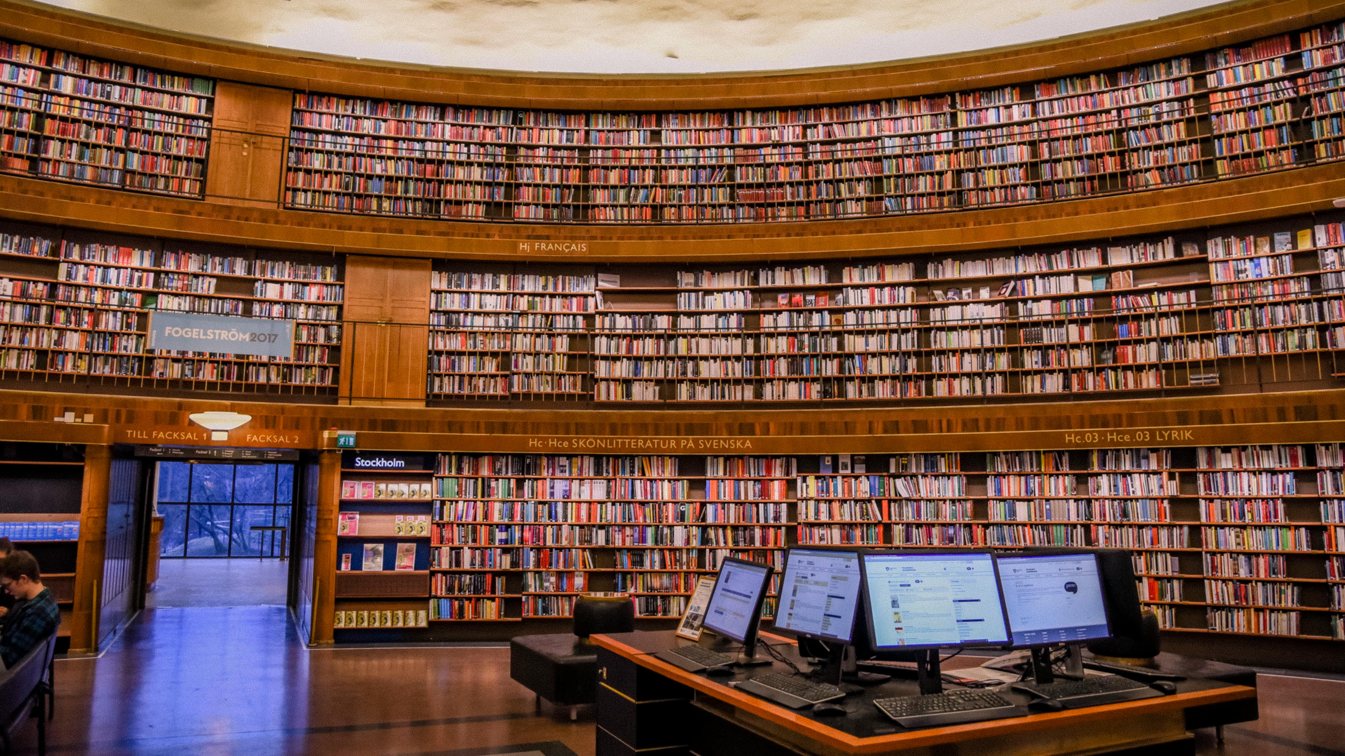 City Library With Bookshelves And Desktop Computers · Free Stock Photo