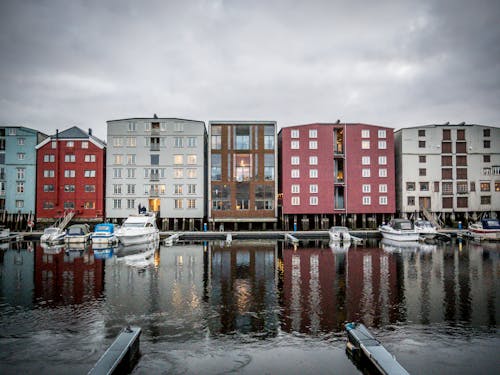 Modern buildings near river with motor boats