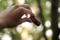 Unrecognizable person showing USB on blurred background