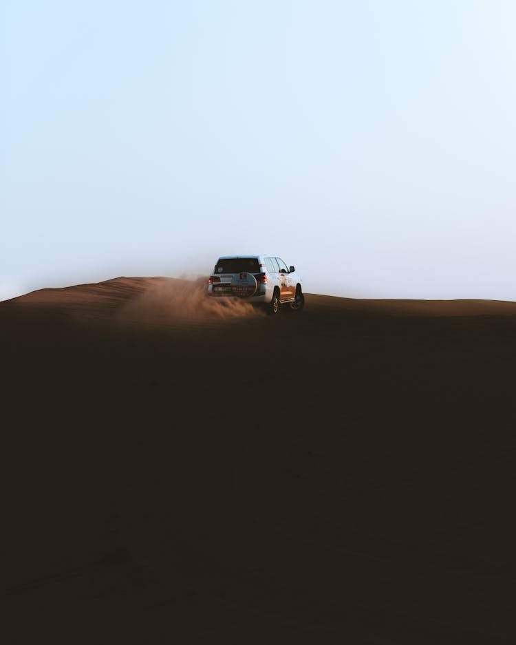 White SUV Driving On Desert