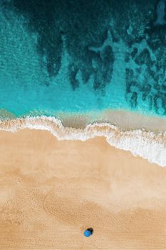 Vibrant aerial view of Pupukea beach in Hawaii with turquoise waters and sandy shores.