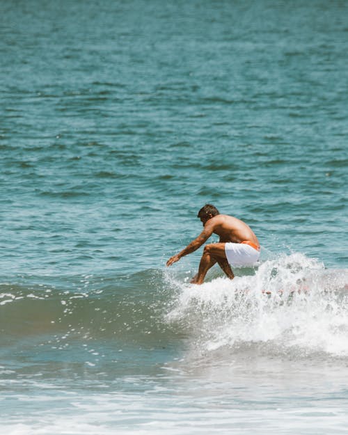 A Man Surfing on the Sea