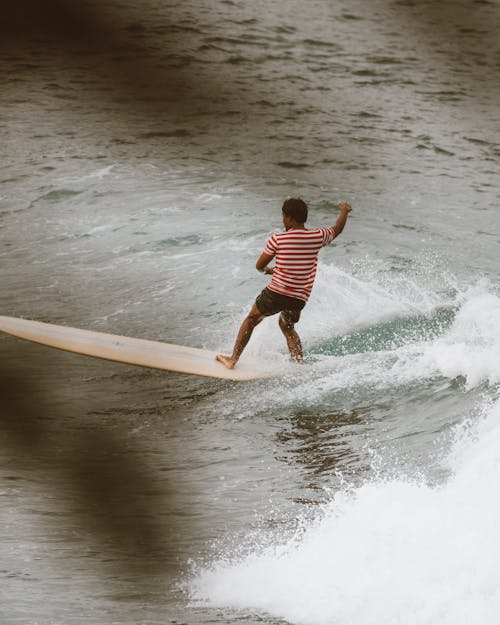 A Man Surfing on the Waves