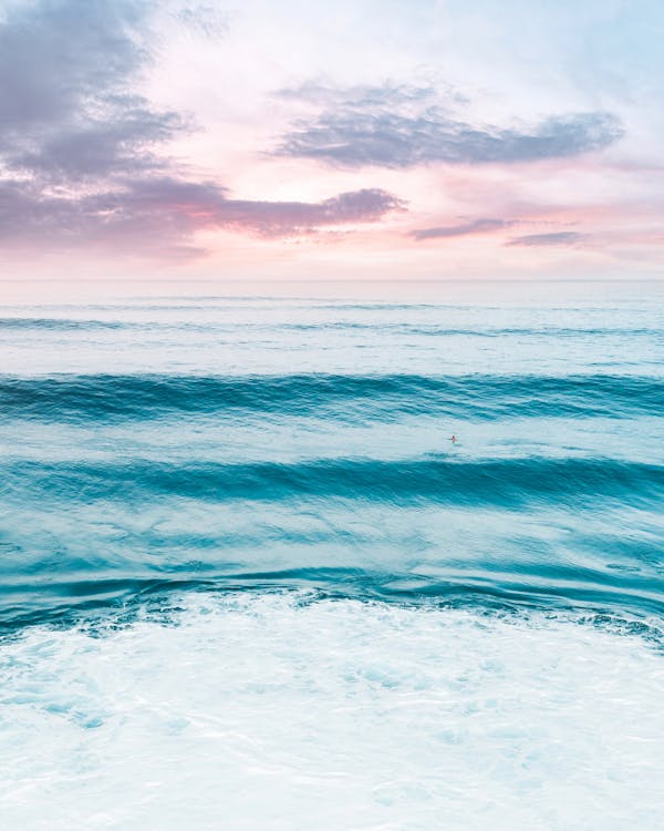 Blue Ocean Water Under Cloudy Sky · Free Stock Photo