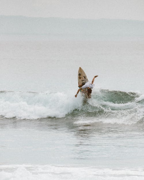 A Man Surfing on Sea Waves