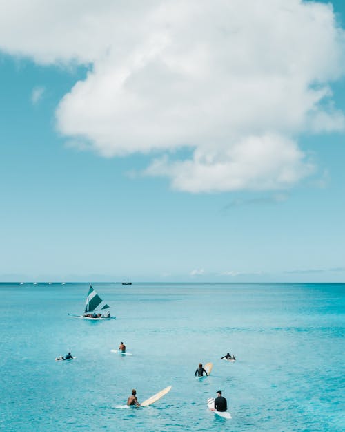 People Surfing on the Sea