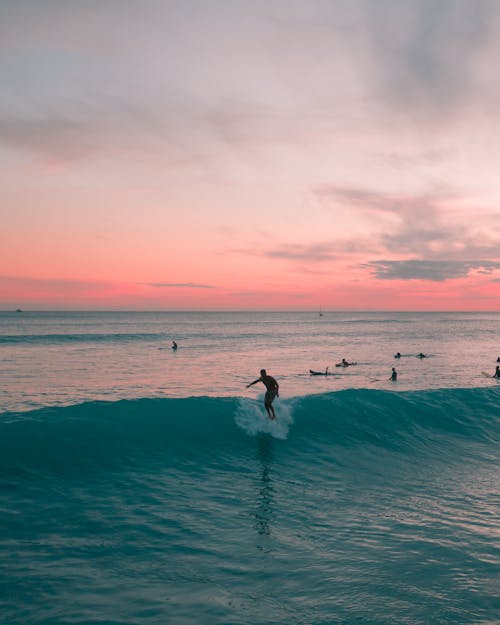 A Man Surfing on Sea