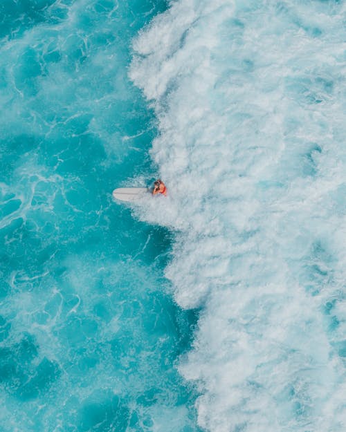 Person in White Surfing Board on Water