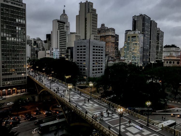 Pedestrian Bridge Near Skyscrapers In Night City