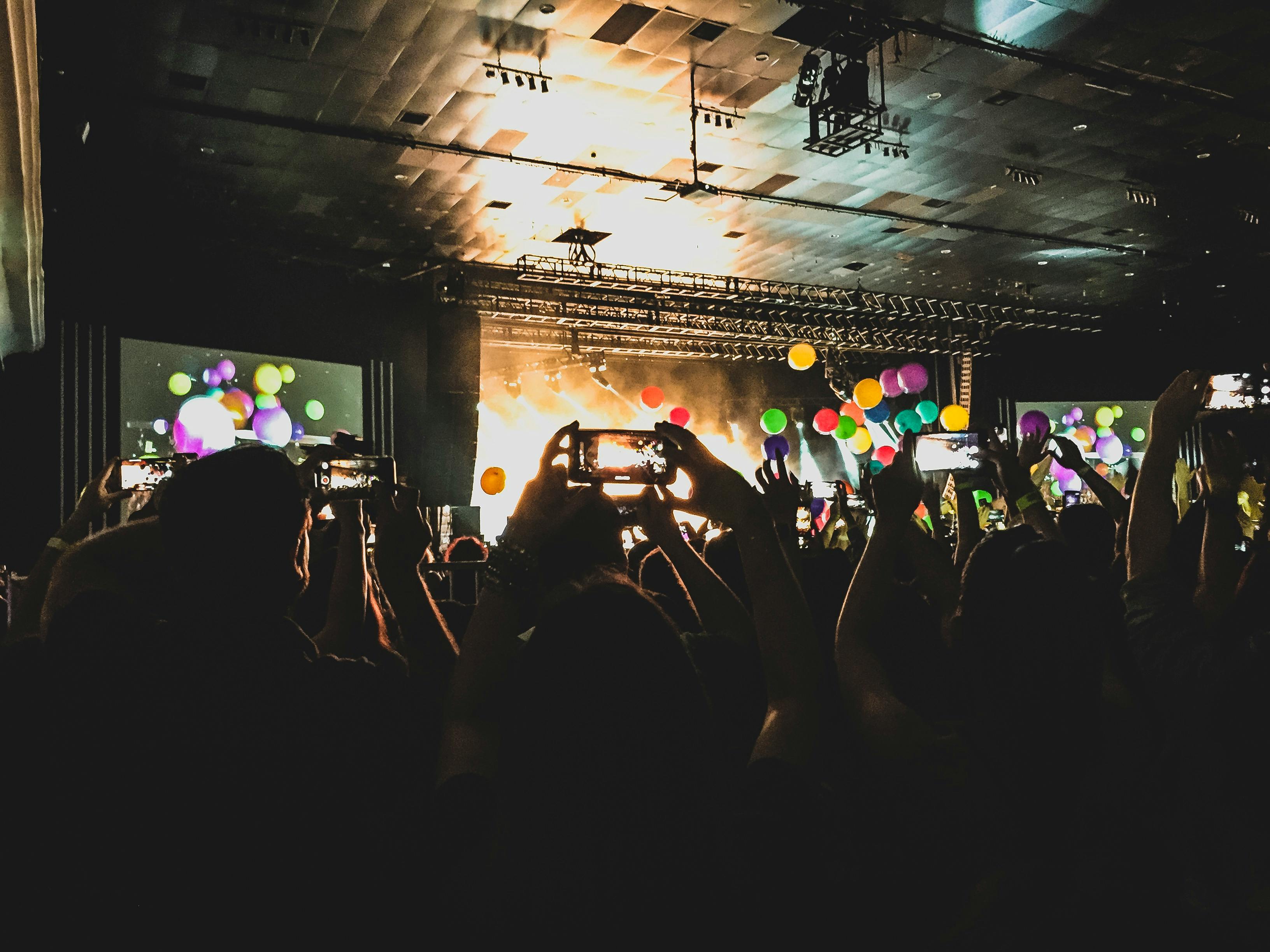 A person holding a handheld gaming console with a vibrant screen, looking excited while playing.
