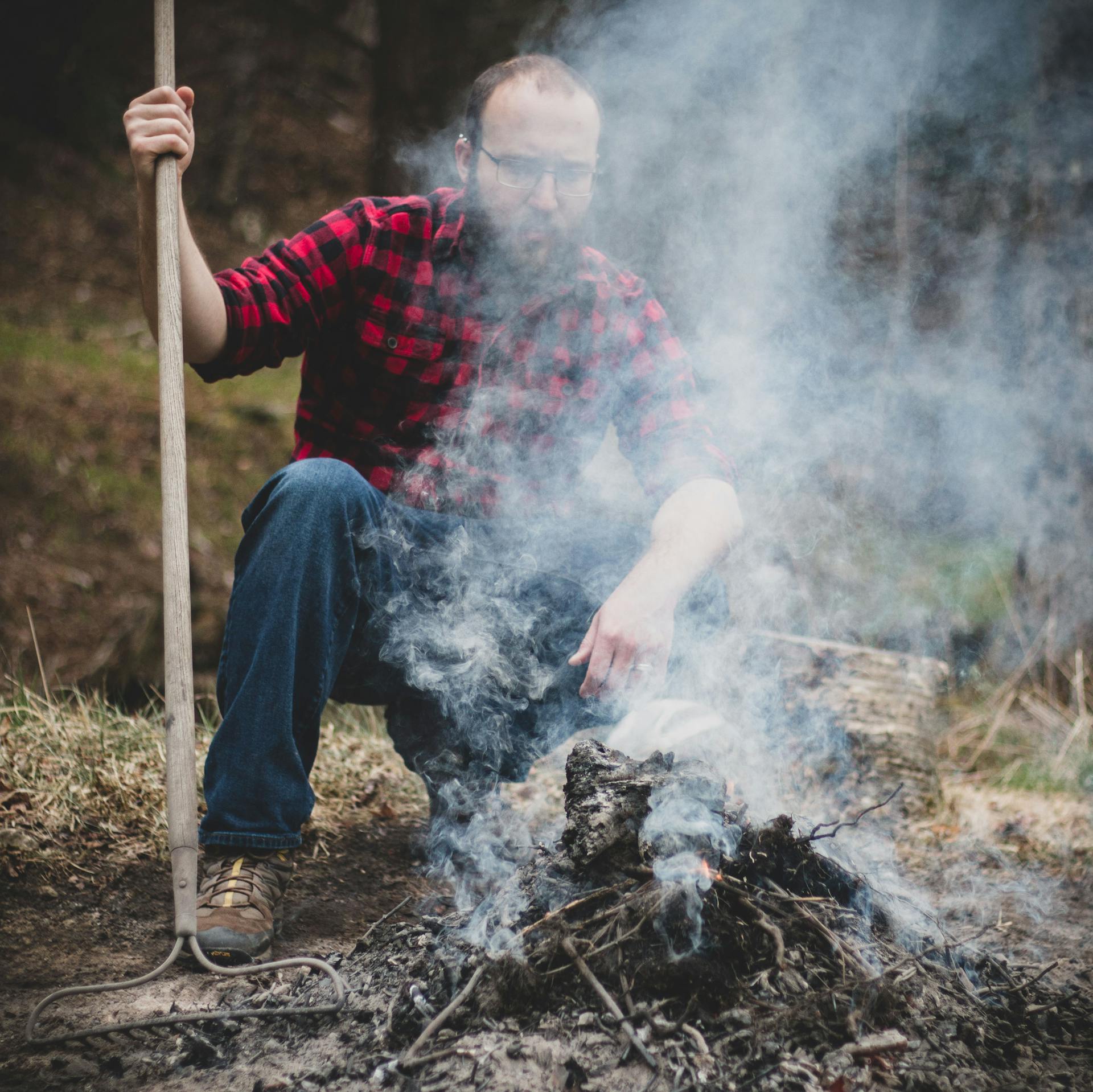 A Man Holding a Rake