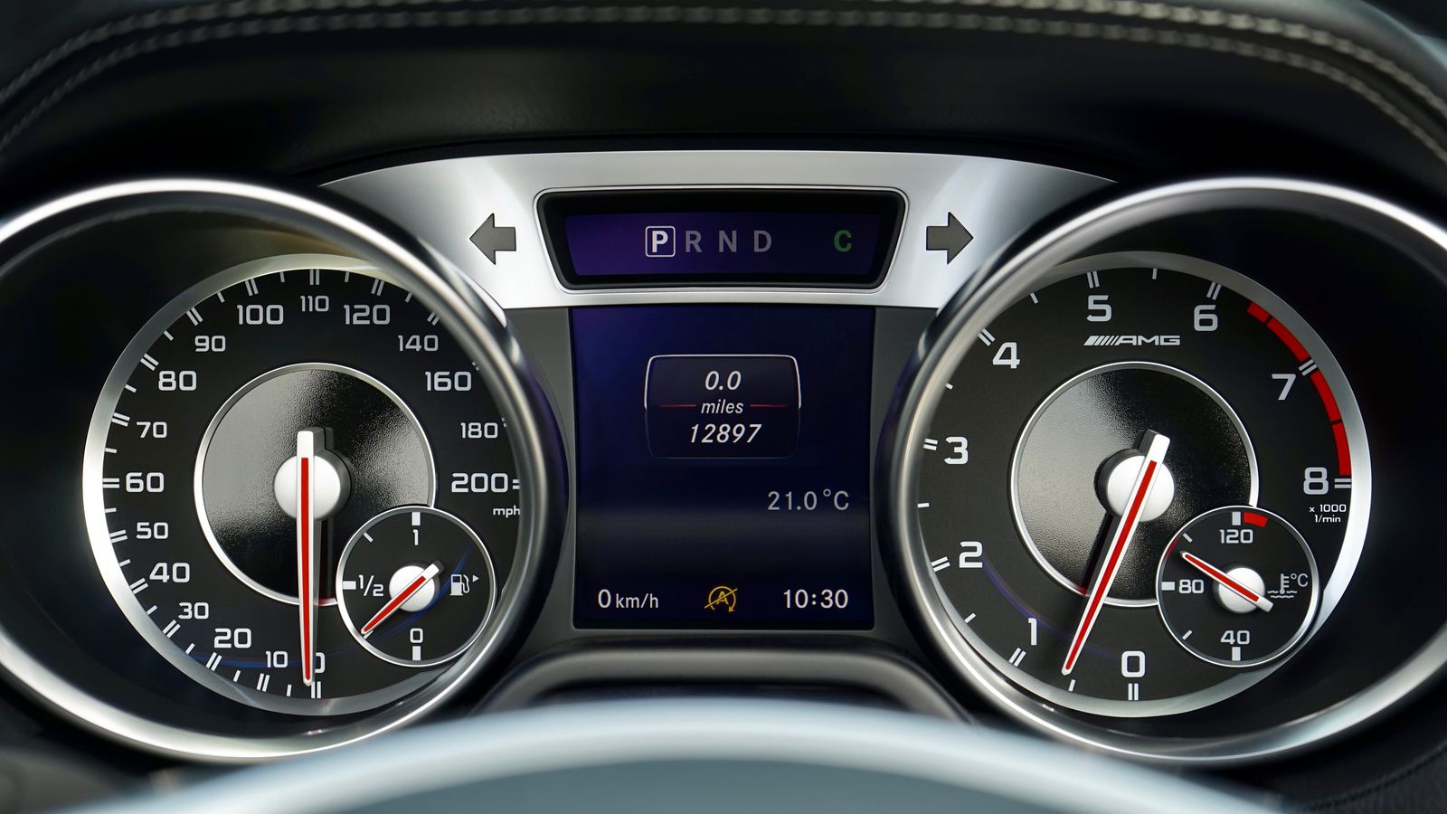 Close-up of a car's instrument cluster showing speedometer and tachometer gauges