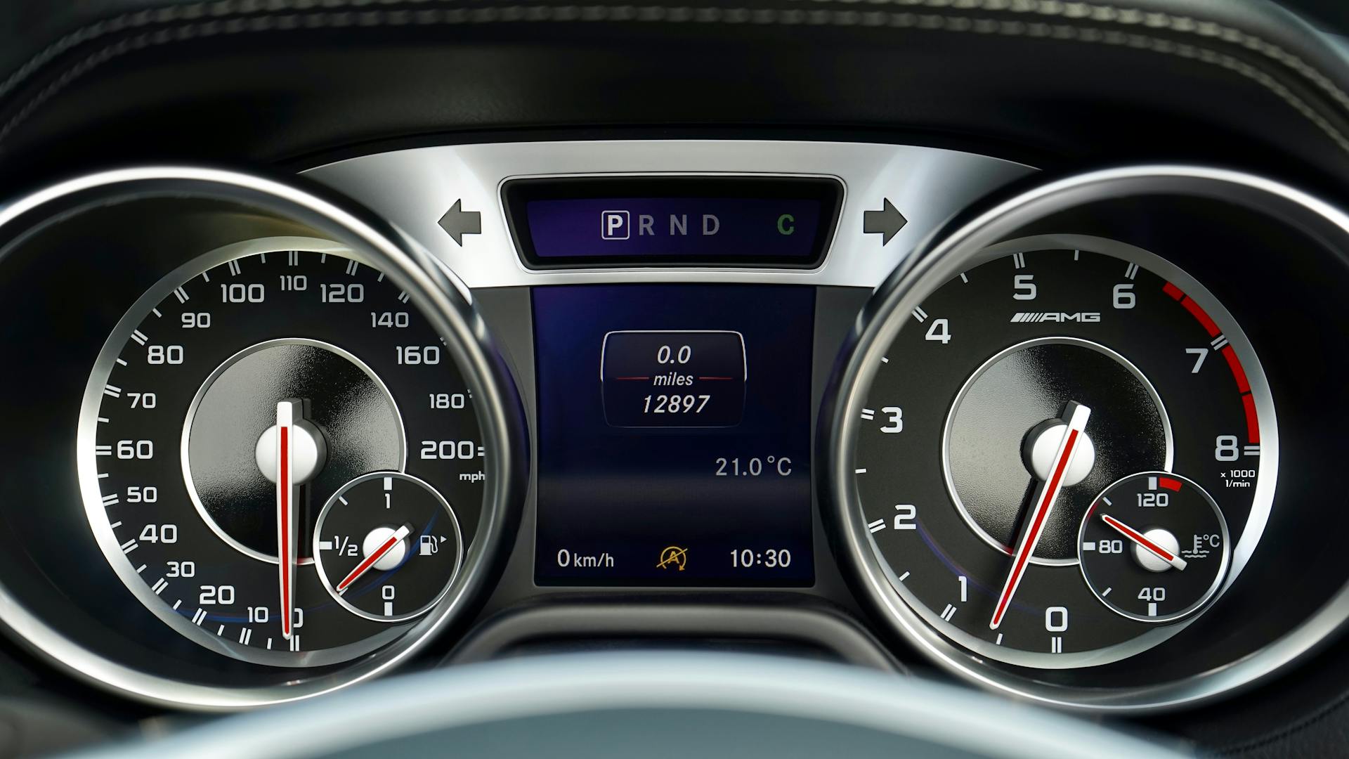 Detailed view of a modern car dashboard showing speedometer, tachometer, and digital display.