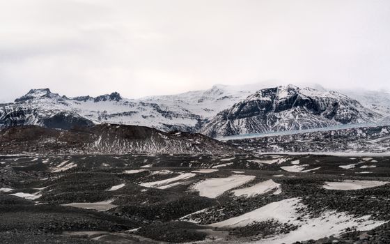 Captivating view of snow-covered Icelandic mountains during winter, highlighting a serene landscape.