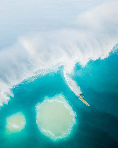 Person Surfing on Blue Ocean Water