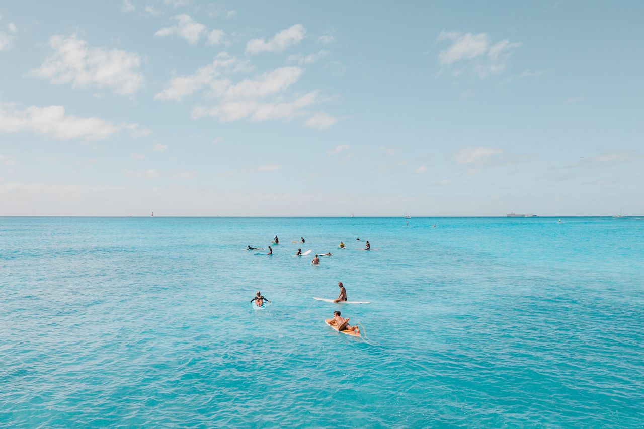 a group of surfers enjoying the clear blue waters of hawaii perfect fo