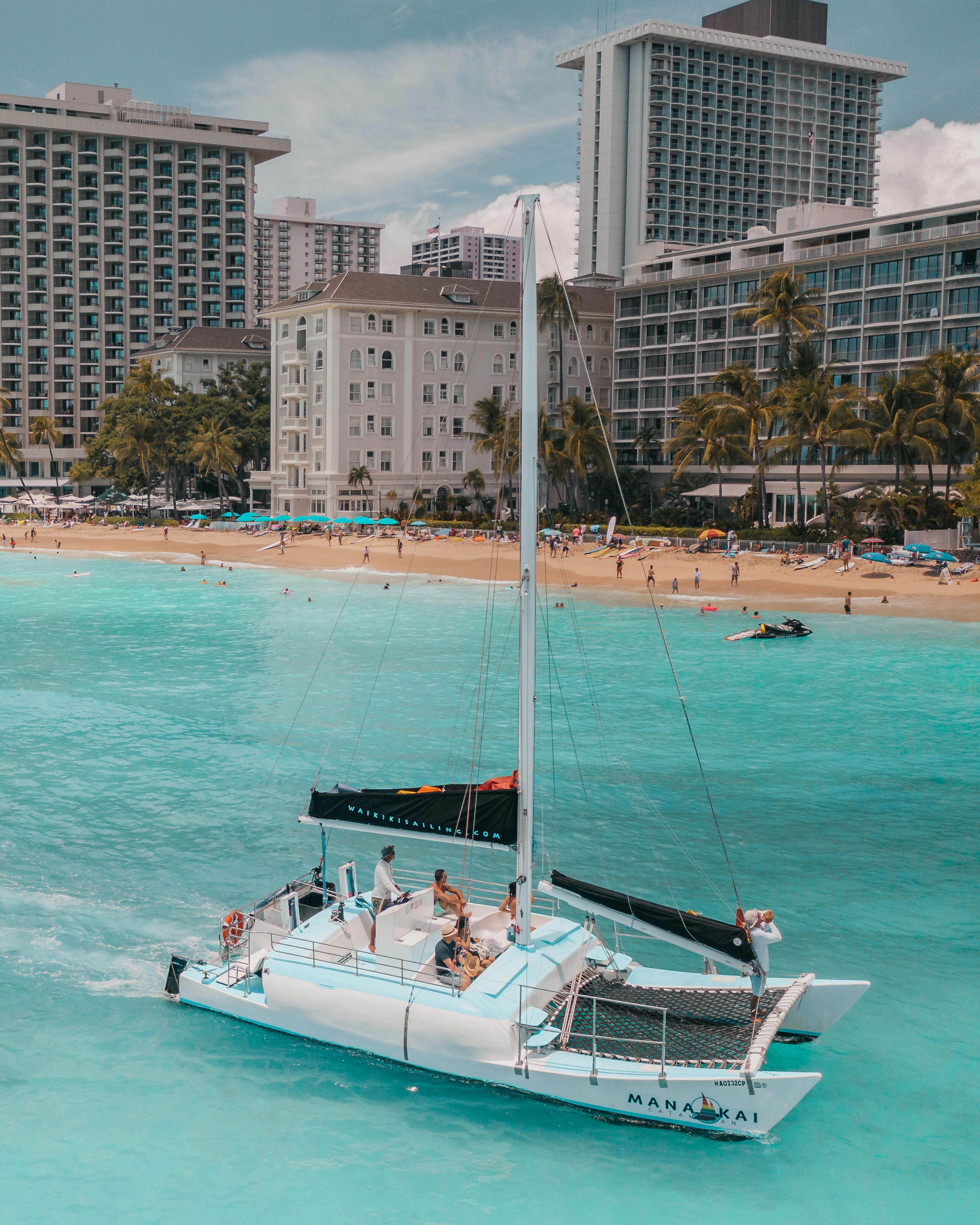 people riding on white and black yacht on sea