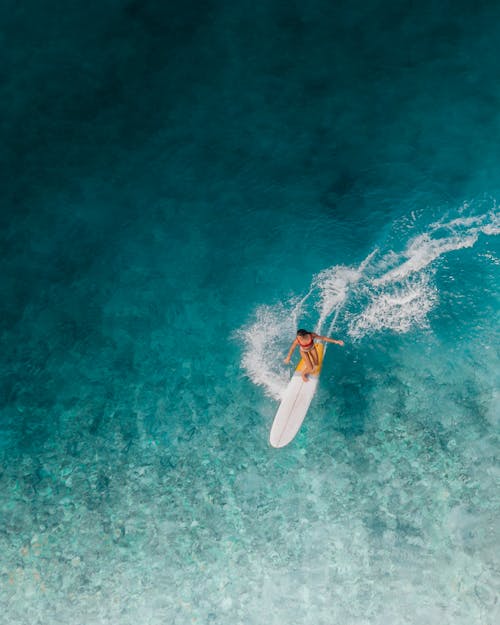 Person Surfing on Sea