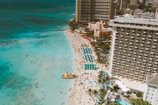 People on Beach Near High Rise Buildings