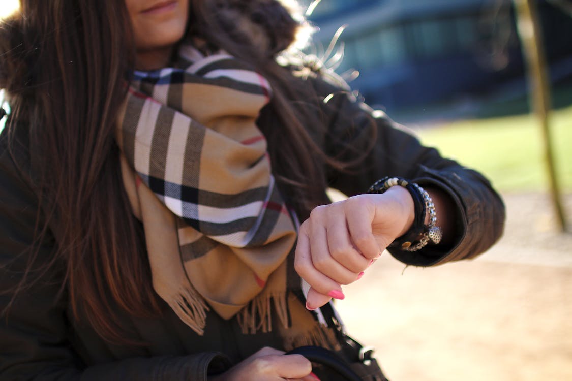 Free Woman Checking Time With Her Wristwatch Stock Photo