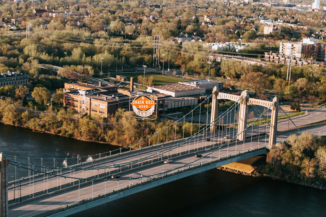 Free Aerial Photography of Moving Cars on the Bridge over River Stock Photo