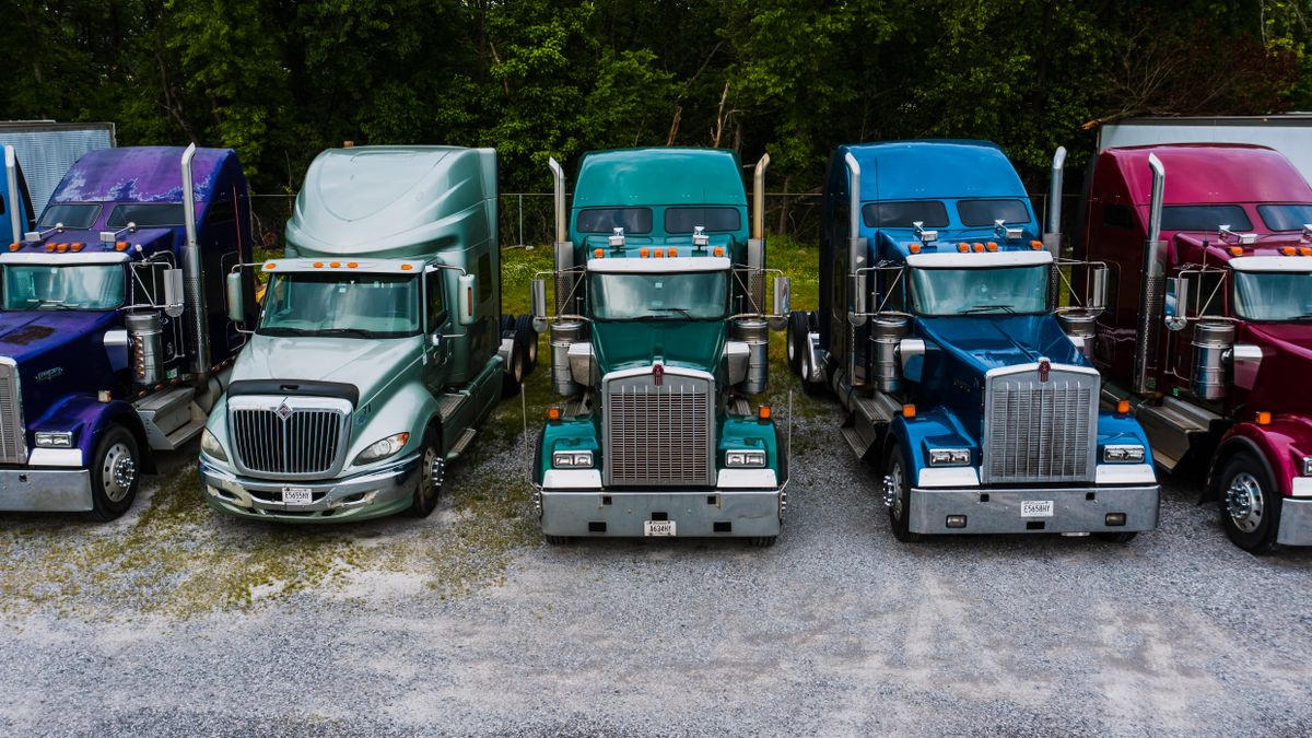 Love's Travel Stops: The Honest Guide to America's Favorite Road Trip Rest Stop 4 Rows of semi trucks parked at a travel stop parking lot