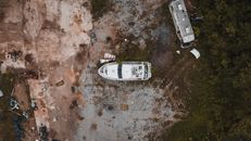 Abandoned yacht and truck junked in countryside