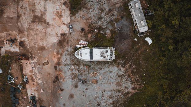 Abandoned yacht and truck junked in countryside