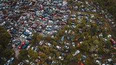 Obsolete vehicles in automobiles graveyard in industrial area