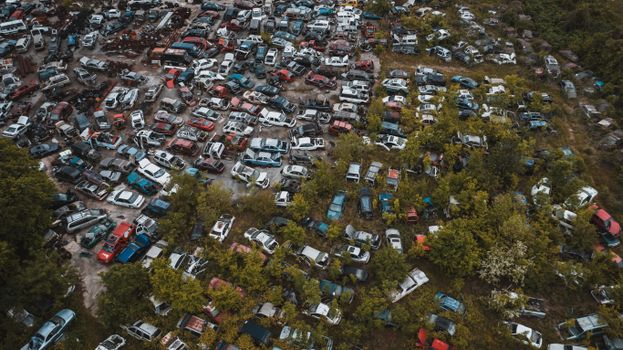 Obsolete vehicles in automobiles graveyard in industrial area