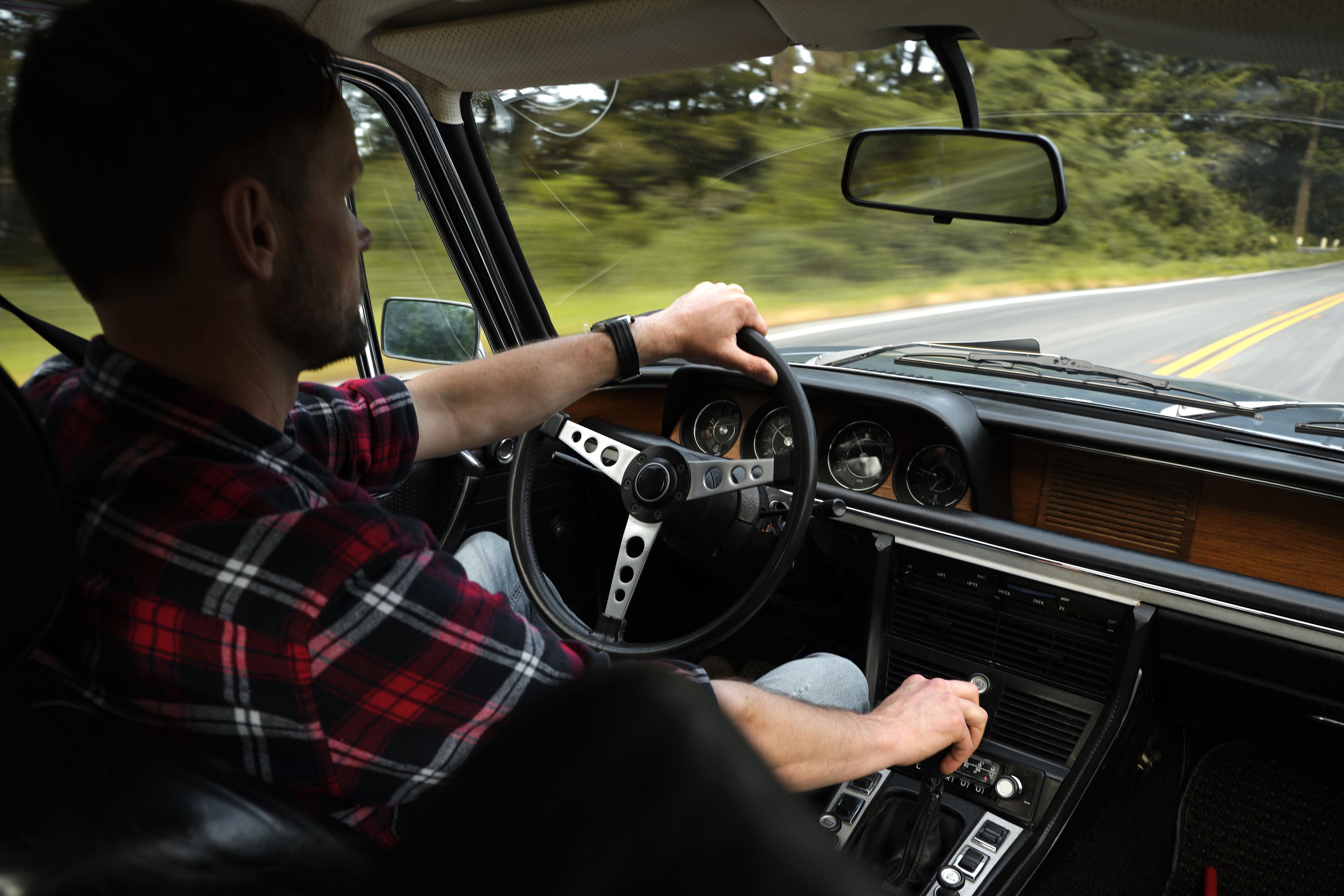 Male driver focused on driving while traveling by car · Free Stock Photo