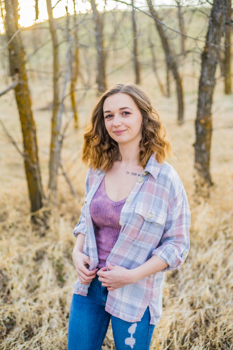 Smiling Young Woman In Sunny Forest