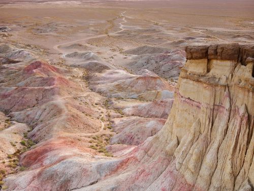 Free Scenic view of rough mount located near dunes covered with various color shades leading to sand terrain in daylight Stock Photo