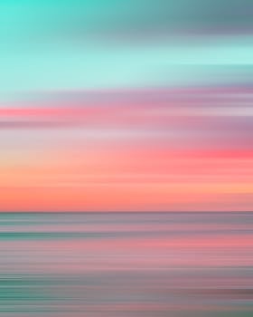 Colorful motion blur capturing a stunning Hawaiian sunset over the ocean.