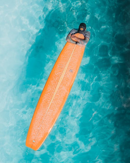 A Man Holding His Surfboard