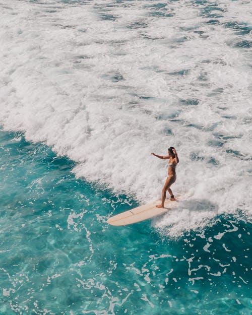 Free Woman in Black Bikini Surfing on Sea Waves Stock Photo