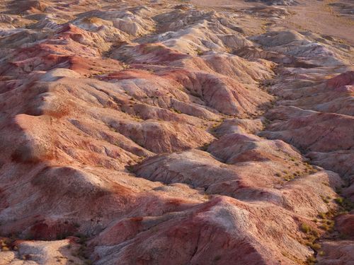Free From above of scenery view of sand hills with different color shades and bumpy surface with loose texture located in desert in afternoon Stock Photo