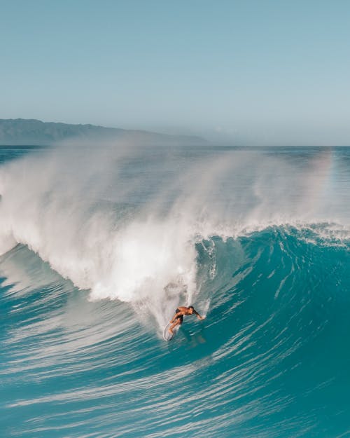 Person Surfing on Sea Waves