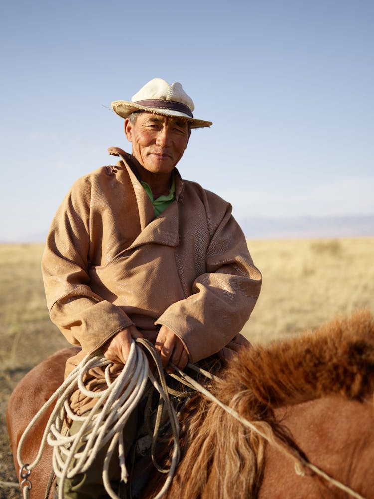 Experienced Mongolian Male Rider In Prairie