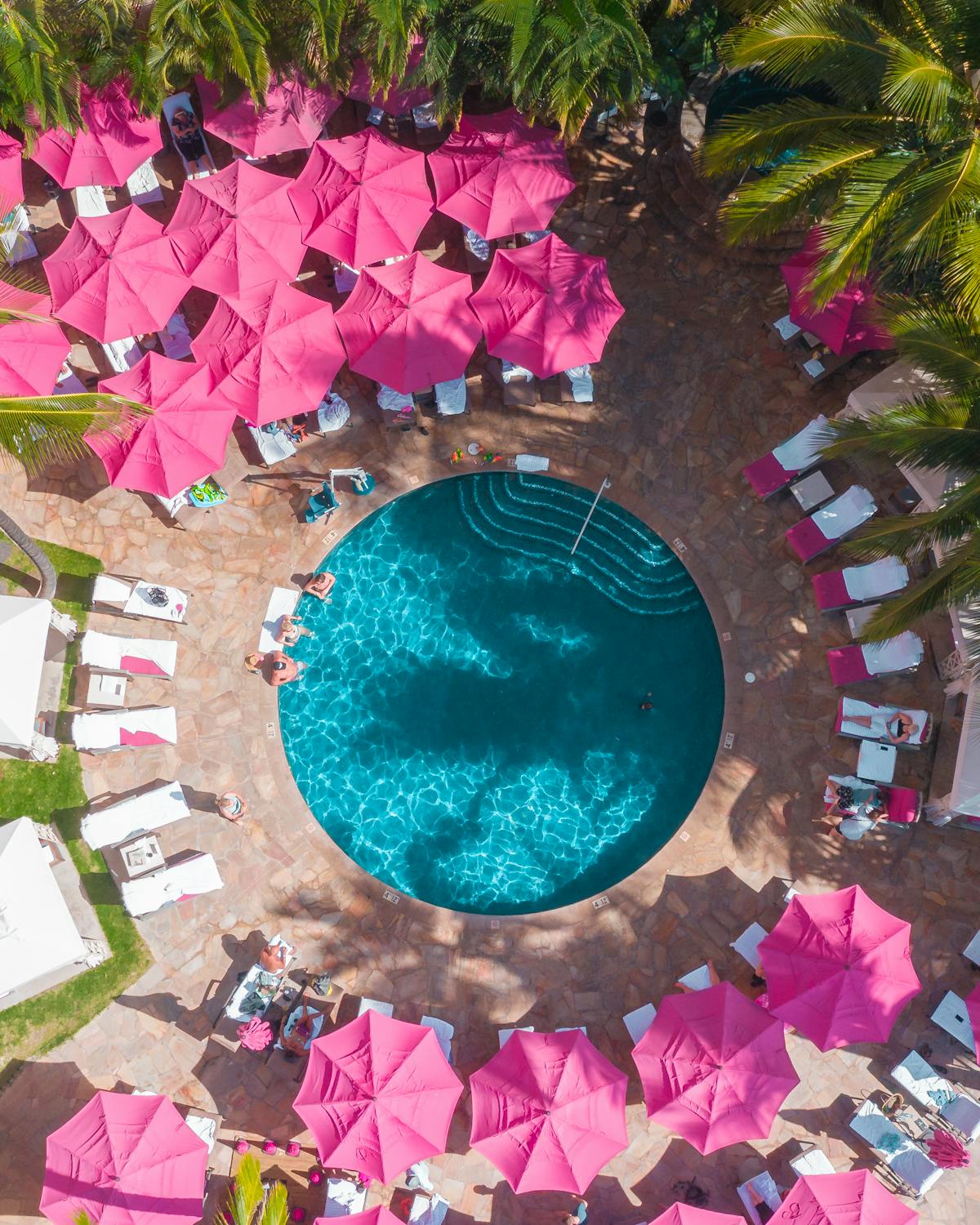 pool party with pink umbrellas for barbie theme backyard party