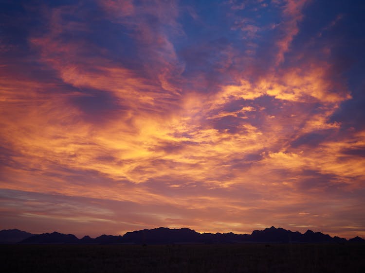 Amazing Sunset Over Mountain Range Silhouette