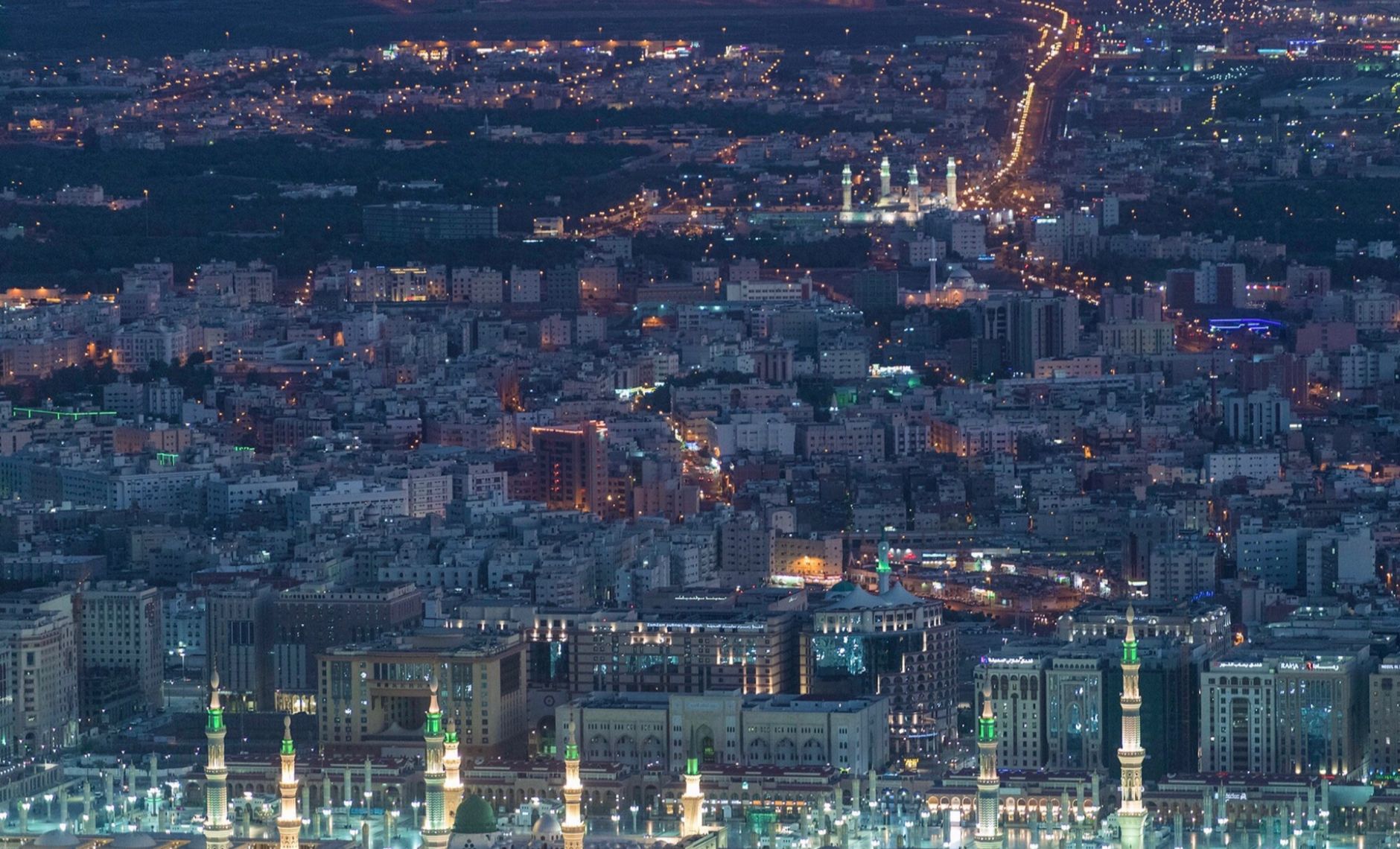 Aerial view of contemporary big metropolis illuminated with glowing city lights at night